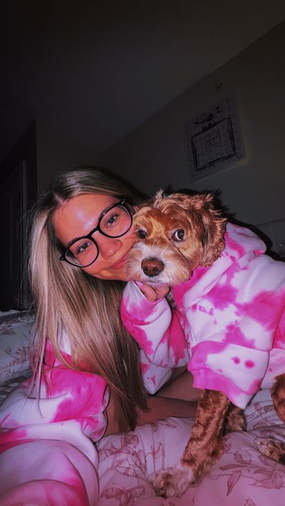 Customer Emilie with her dog in matching pink tie-dye Comfrt outfits